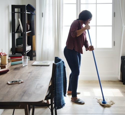 Black woman cleaning room